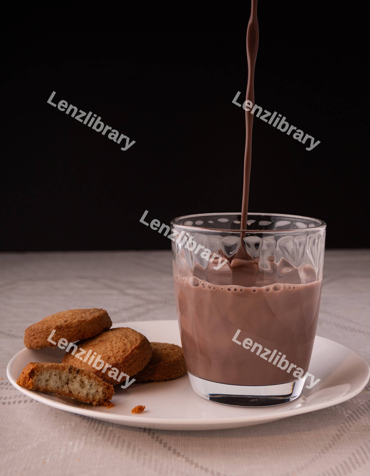 Chocolate milk falling on the glass